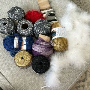 Various leftover yarns and a feather boa for crafts